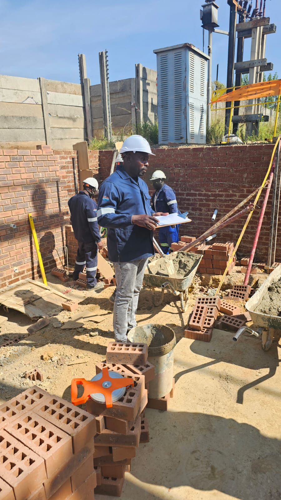 Construction team at wall base